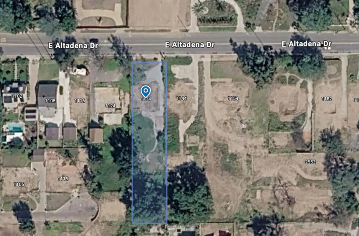 Aerial parcel map of a fire-cleared residential lot on E Altadena Drive, marked for tracking amid still-standing neighboring homes
